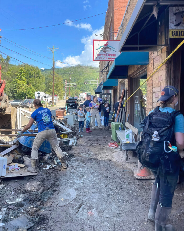 Volunteers clear flood debris on Bridge Street in Hot Springs, outside the Hot Springs Public Library, after Hurricane Helene